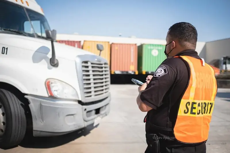 A Galaxy officer checking a semi truck at the gate