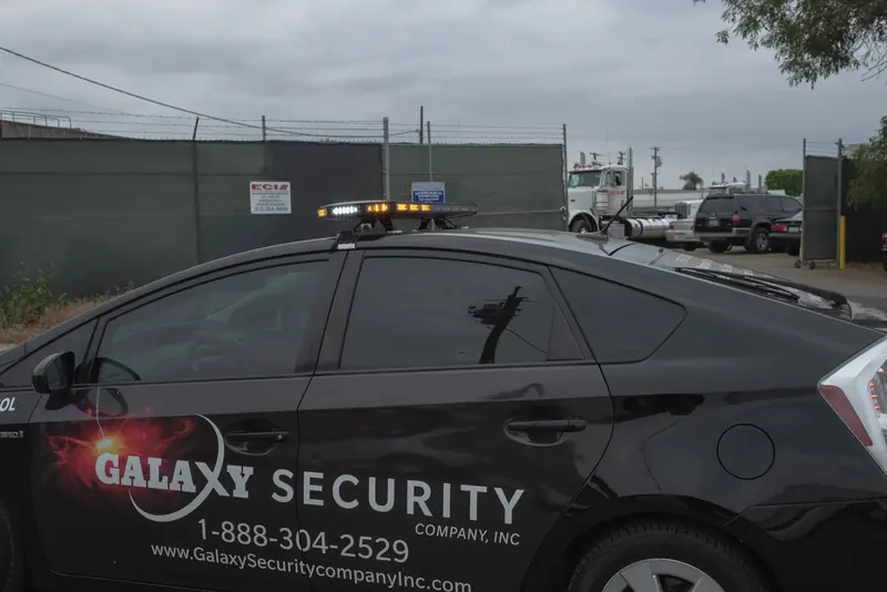 A Galaxy patrol car in a fenced truck yard