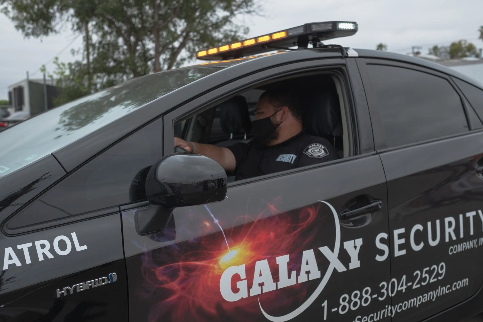 A Galaxy officer in a marked patrol car